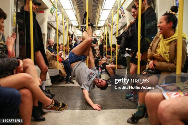 People ride the District Line without trousers on January 12, 2020 in London, England. Originating as a prank on the New York Subway, the "No Pants...