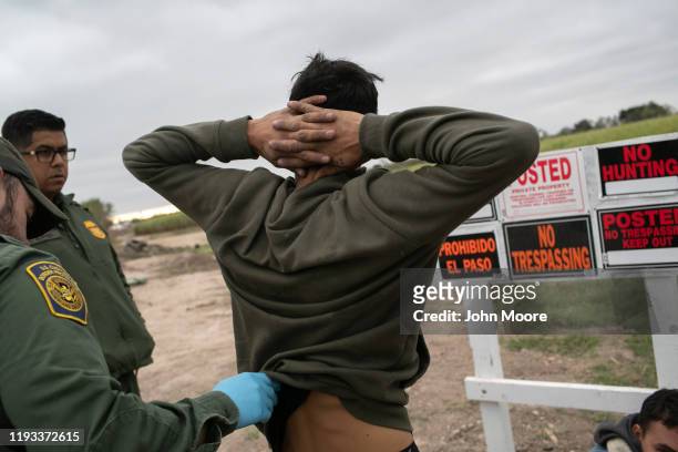 Border Patrol agents detain undocumented immigrants caught near a section of privately-built border wall under construction on December 11, 2019 near...