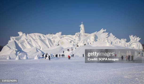 Tourists visit ice sculpture during the 36th Harbin Ice and Snow Festival in Harbin, Heilongjiang province. Harbin International Ice and Snow...