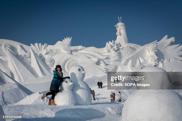 Tourists visit ice sculpture during the 36th Harbin Ice and Snow Festival in Harbin, Heilongjiang province. Harbin International Ice and Snow...