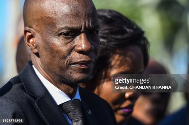 President of Haiti Jovenel Moise offers bouquet of flowers at the mass graveyard during the commemorative ceremonies of Haiti's 10th earthquake...