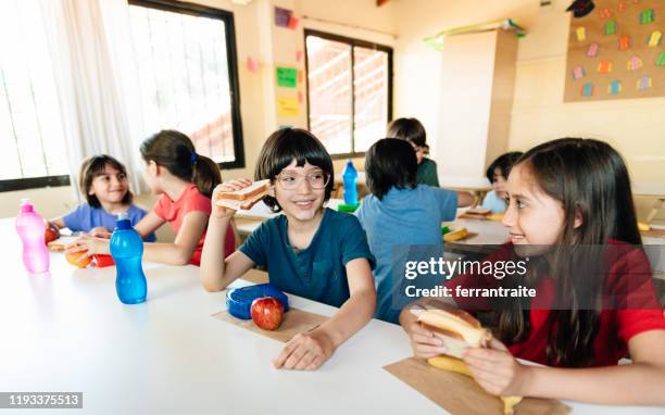 elementary students at lunch break in school cafeteria - boy packlunch stock pictures, royalty-free photos & images