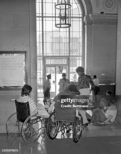 Demonstrators in wheelchairs picket lobby of the Federal Building as they concluded their first week of a sit-in in offices of HEW department, in...