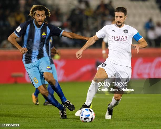 Gabriel Fernández Arenas and Cédric Sansot battle for the ball during the FIFA Club World Cup First Round between Al Sadd and Hienghène Sport at the...