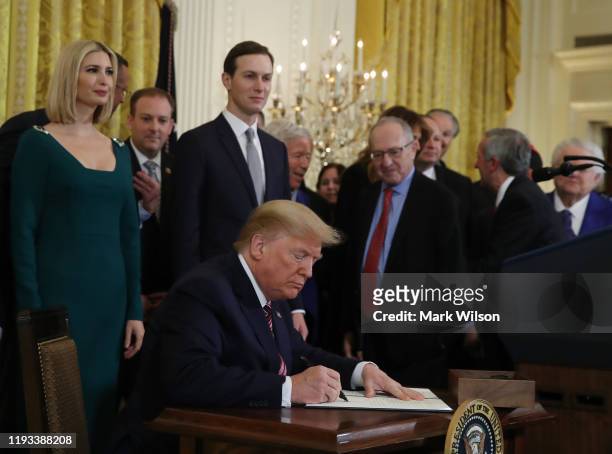 President Donald Trump signs an executive order to combat anti semitism during a Hanukkah Reception in the East Room of the White House on December...