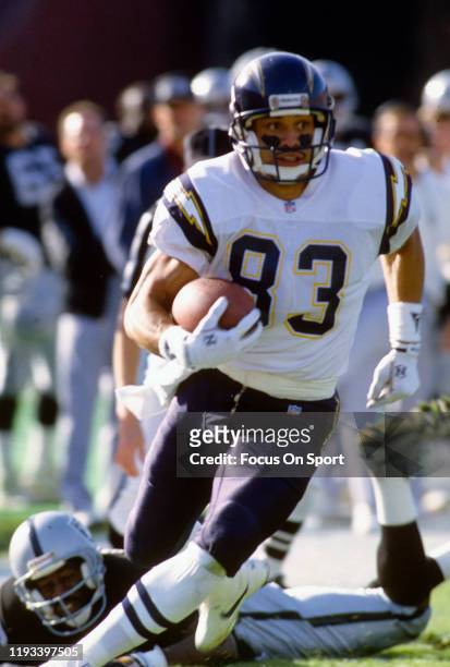 Anthony Miller of the San Diego Chargers runs with the ball against the Los Angeles Raiders during an NFL football game December 20, 1992 at the Los...
