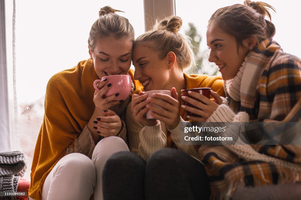 Close-up of happy close female friends sharing cozy time