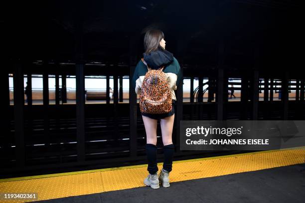 Participants in the 19th Annual "No Pants Subway Ride" wait to board a train in the subway on January 12, 2020 in New York. - The "No Pants Subway...