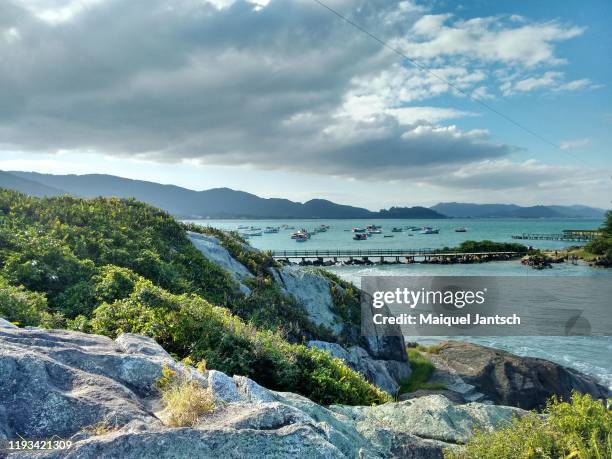 walkway between the beach and an island at armação beach in florianopolis, santa catarina - brazil - florianopolis stock-fotos und bilder