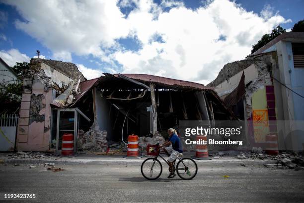 Cyclist rides past a destroyed building in Guanica, Puerto Rico, on Sunday, Jan. 12, 2020. Puerto Rico was hit by a series of earthquakes over the...