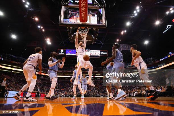 Aron Baynes of the Phoenix Suns slam dunks the ball against the Memphis Grizzlies during the second half of the NBA game at Talking Stick Resort...