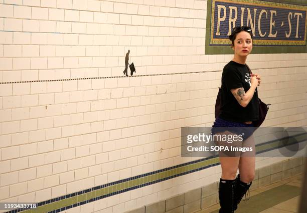 Woman with no pants waits in the subway. As a part of a comedic stunt in 2002 seven riders took their first "No Pants Subway Ride" in New York City....