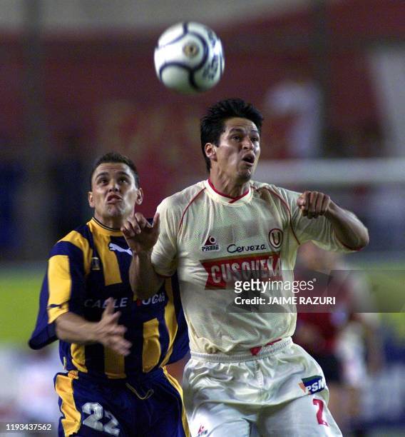 Soccer players Jorge Araujo of Universitario and Fedetrixco Arias of Rosario Central fight for the ball 20 March 2001 in Lima, Peru. Los jugadores...