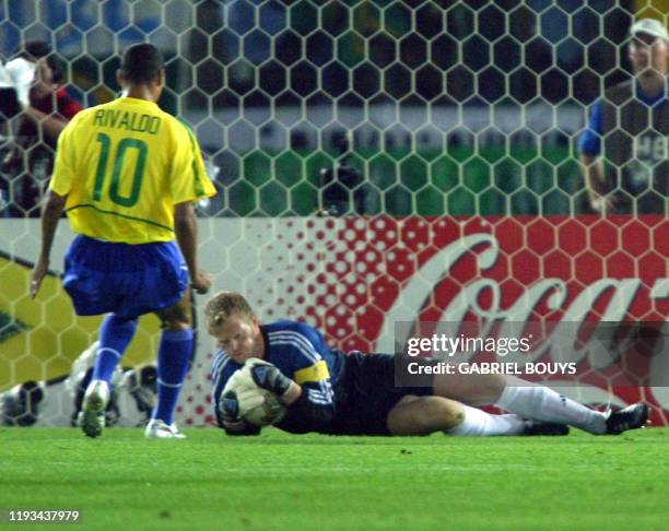 Germany's team captain and goalkeeper Oliver Kahn makes a save of an offensive from Brazil's midfielder Rivaldo in the first minutes of match 64 of...