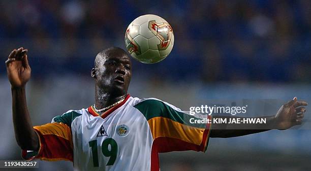 Senegalese midfielder Pape Bouba Diop heads the ball during his opening game with France for the 2002 FIFA World Cup Korea/Japan in Seoul, 31 May...