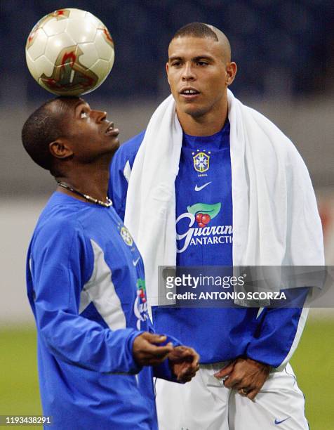 Brazilian ace striker Ronaldo Nazario observes teammate Edilson as he controls the ball 24 June 2002 during a training session at Saitama World Cup...