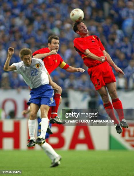 Japan's Daisuke Ichikawa , Belgium's team captain and forward Marc Wilmots and midfielder Bart Goor are airborne during match 13 group H of the 2002...