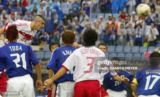 Turkey's midfielder Umit Davala soars over players , Japan's midfielder Kazuyuki Toda, defender Koji Nakata, Turkey's defender Bulent Korkmaz,...