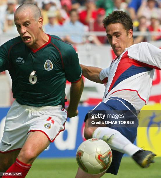 S Josh Wolff beats Mexico's Gerardo Torrado to the ball , 17 June 2002 at the Jeonju World Cup Stadium in Jeonju, during second round playoff action...