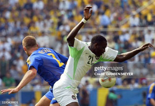 Nigeria's forward John Utaka and Sweden's defender Olof Mellberg vie for the ball during match 21 group F of the 2002 FIFA World Cup Korea Japan...