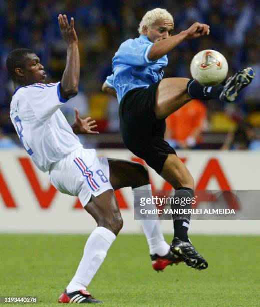 Dario Silva of Uruguay beats French defender and captain Marcel Desailly to the ball, 06 June 2002 at the Busan Asiad Main Stadium in Busan, during...