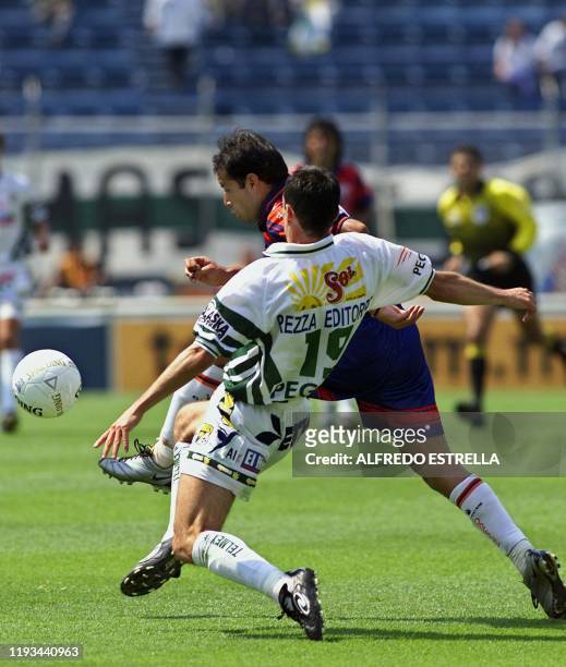 Sigifredo Mercado of the Leon team fights for the ball with Jose Manuel Abundis of the Atlante, during a match on the 14th day of the Summer...