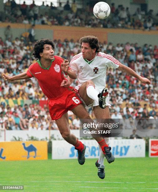 Moroccan midfielder Abdelmajid Dolmy collides with Portuguese Magalhaes as he goes for the ball 11 June 1986 in Guadalaraja during the World Cup...