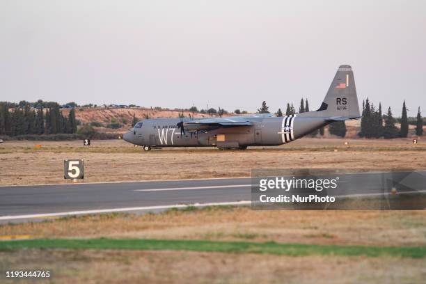An Iconic C-130 military transport turboprop aircraft during the takeoff phase. The American plane, a Lockheed Martin C-130J-30 Super Hercules of the...