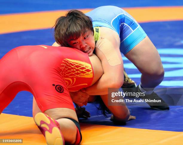 Hiroe Minagawa of Japan and Zhou Qian of China compete in the Women's 76kg quarter final on day five of the World Wrestling Championships at the...