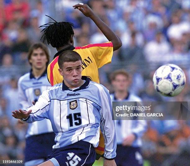 Andres D'Alessandro of Argentina and Abdul Ibrahim of Ghana vie for the ball during their World Cup Sub-20 Championship Soccer final 08 July 2001 at...