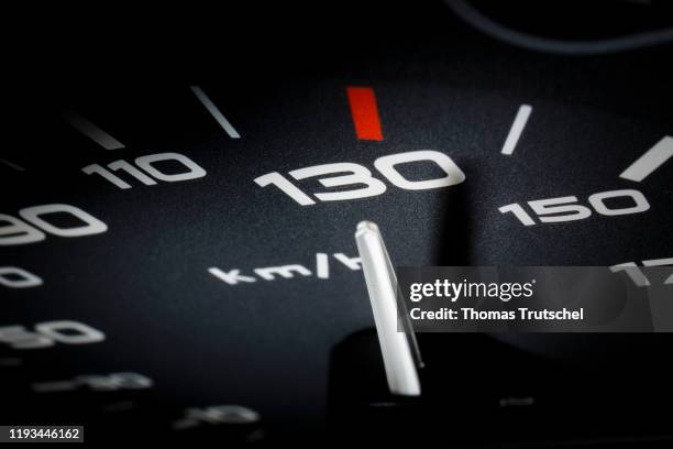 Symbolic photo on the subject of speed limit 130 km / h. A speedometer needle can be seen on a speedometer next to the display for 130 kilometers per...