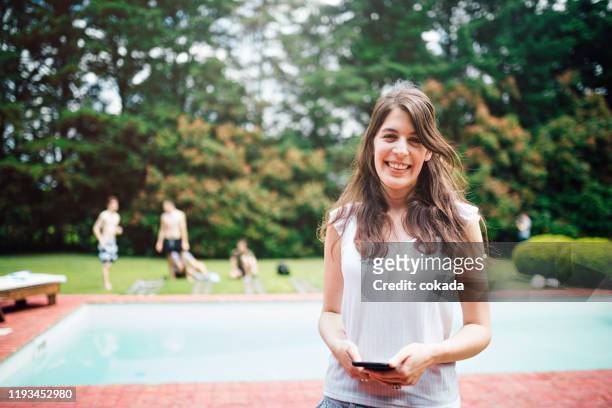 friends spending time together at swimming pool - country club woman stock pictures, royalty-free photos & images