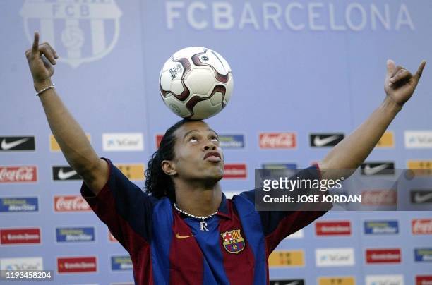 Barcelona's new Brazilian soccer star Ronaldinho balances the ball on his head during his official presentation at the Nou Camp Stadium in Barcelona,...