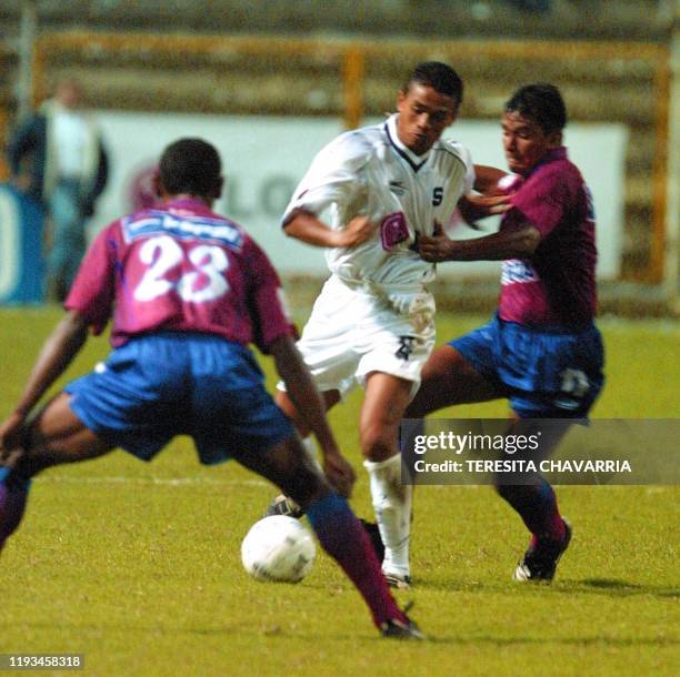 Israel Donis del Cid watches as Walter Centeno approaches with the ball, meanwhile Eduardo Barros plays defense in San Jose, Costa Rica 12 September...