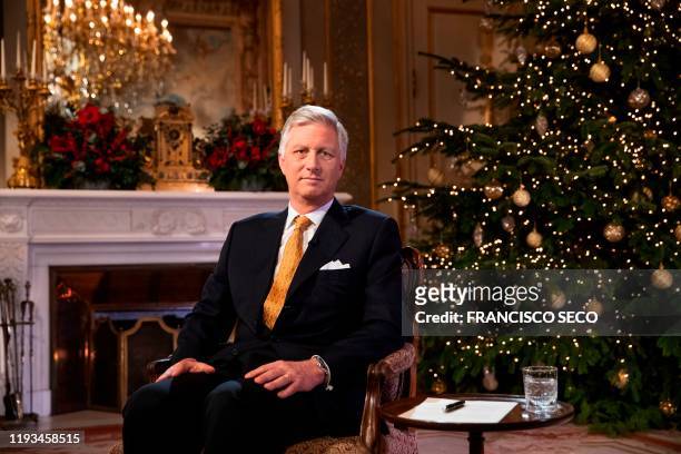 King Philippe of Belgium poses during the recording of his yearly Christmas message and nea year wishes at the Royal Palace in Brussels on December...