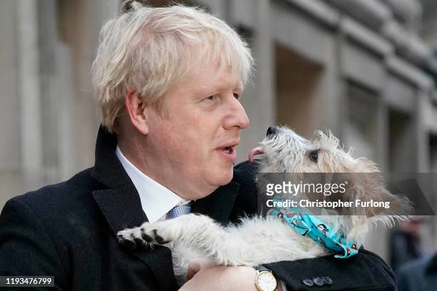 Prime Minister Boris Johnson poses outside Methodist Hall polling station as he casts his vote with dog Dilyn, on December 12, 2019 in London,...