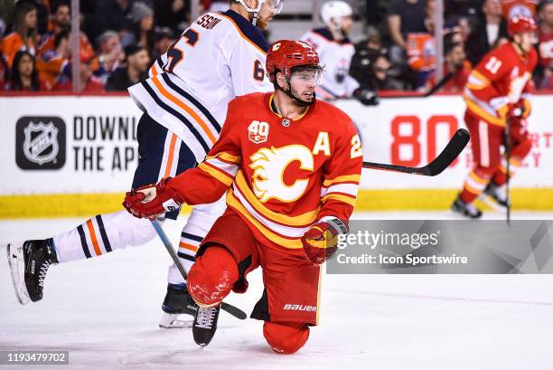 Calgary Flames Center Sean Monahan gets up after being taken to the ice during the second period of an NHL game where the Calgary Flames hosted the...
