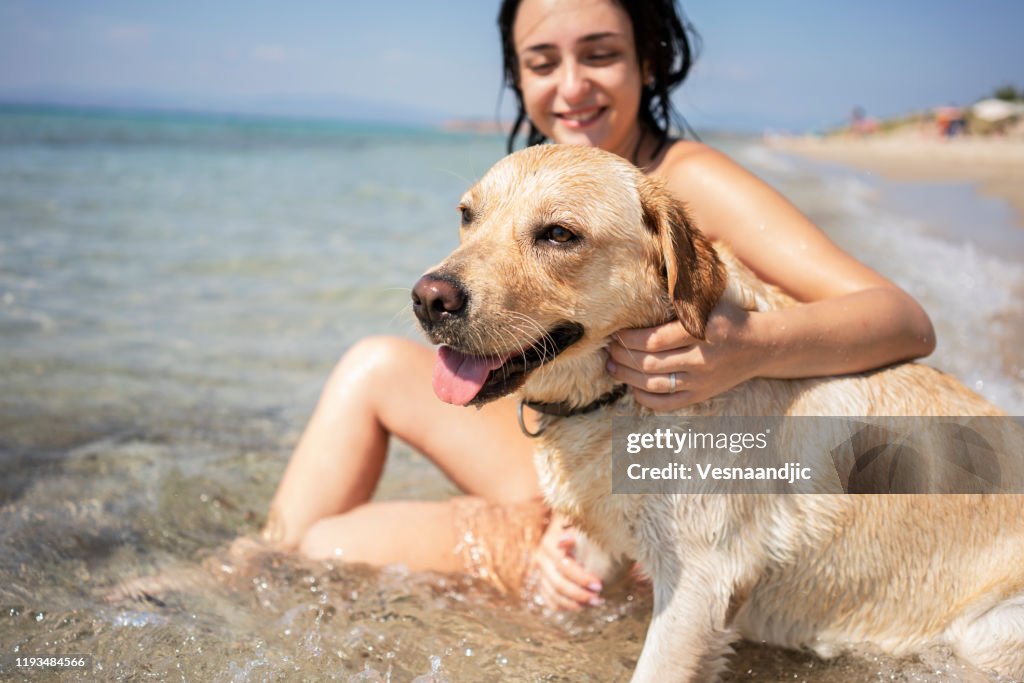 Young woman having fun with her dog