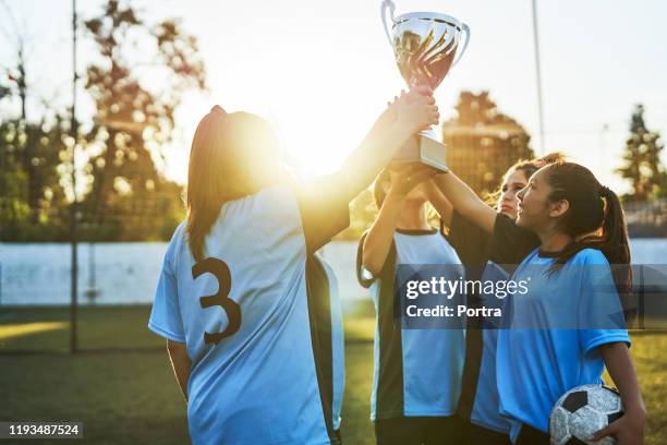 soccer players with trophy celebrating success - argentina girls stock pictures, royalty-free photos & images