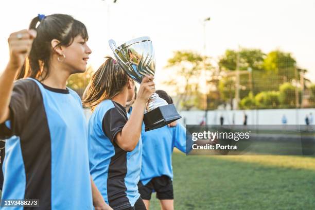 soccer girls with trophy on sports field - trophy day 3 stock pictures, royalty-free photos & images