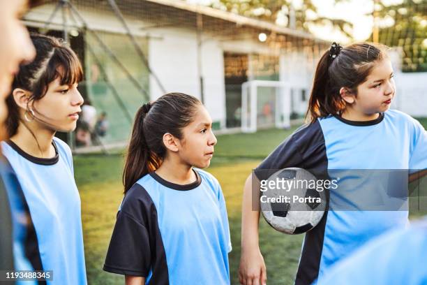 soccer girls looking away while standing on field - argentina girls stock pictures, royalty-free photos & images