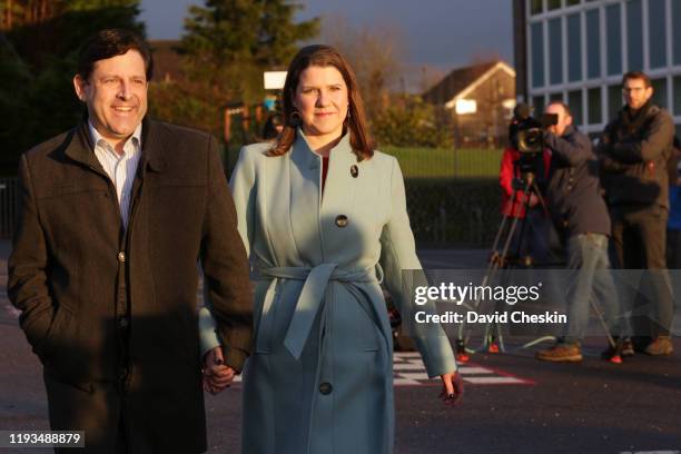 Liberal Democrat Leader Jo Swinson and her husband Duncan Hames arrive to vote at Castlehill Primary School on December 12, 2019 in Bearsden, near...