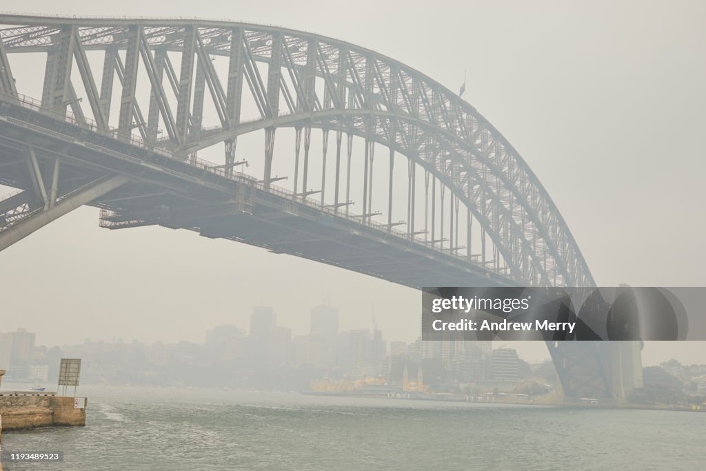 Sydney Harbour Bridge in smoke haze, air pollution from forest fires, bushfires in Australia