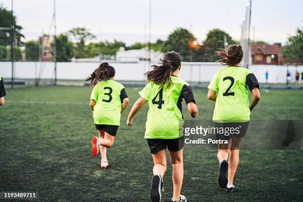 female soccer players warming up before match - girl from behind stock pictures, royalty-free photos & images