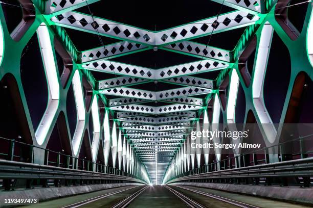 night view of illuminated starý most - old bridge, landmark of bratislava - radial symmetry photos et images de collection