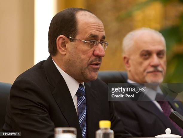 Iraqi Prime Minister Nouri al-Maliki, left, speaks during a bilateral meeting with Chinese President Hu Jintao at the Great Hall of the People on...