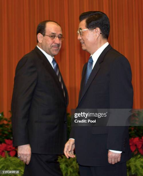 Iraqi Prime Minister Nouri al-Maliki, left, meets with Chinese President Hu Jintao ahead of a bilateral meeting at the Great Hall of the People on...