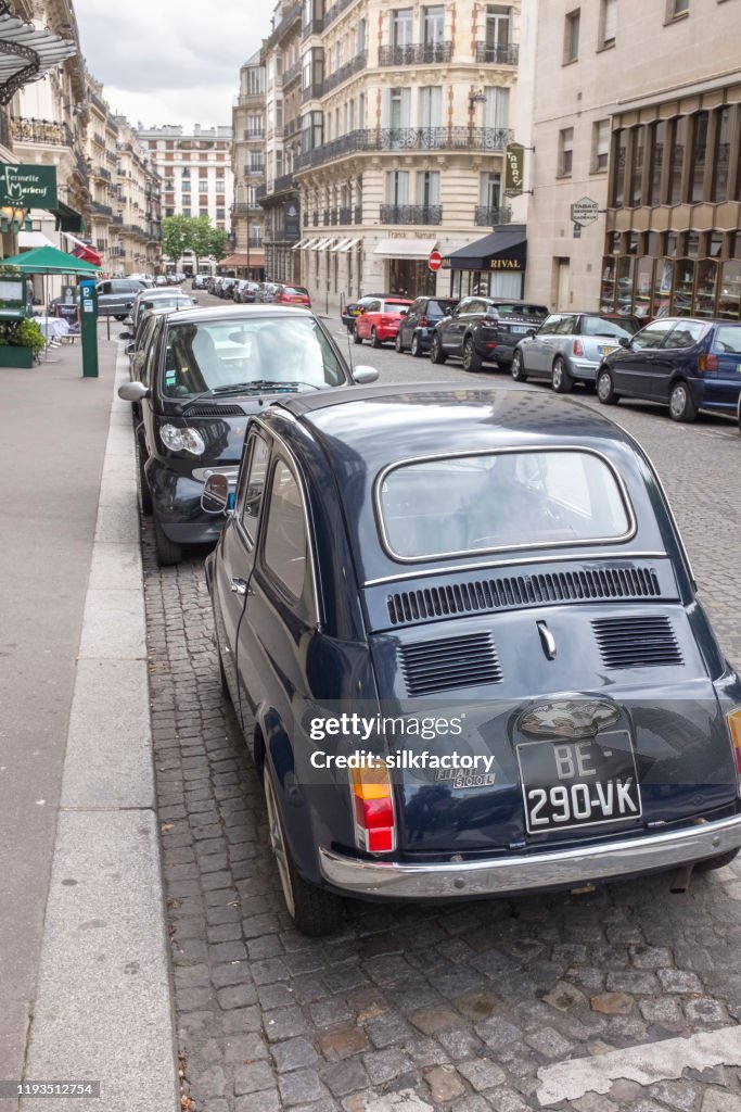 Vintage Fiat 500 car parked in Rue Marbeuf near Avenue des Champs-Elysees in Paris in spring