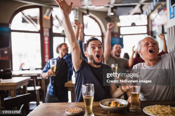 friends watching soccer match - senior men beer stock pictures, royalty-free photos & images