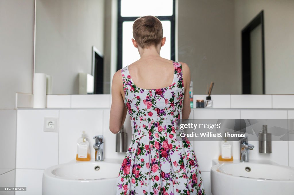 Young Woman Getting Dressed In Bathroom
